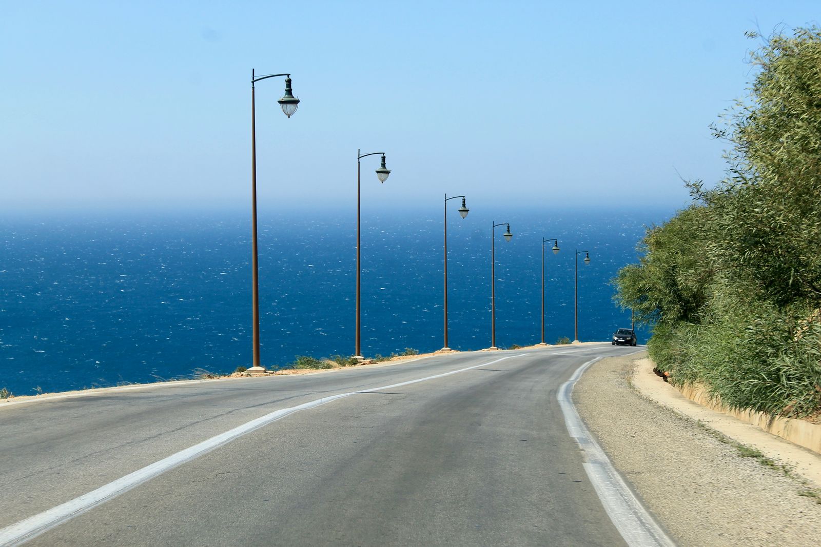 Car driving along a winding coastal road