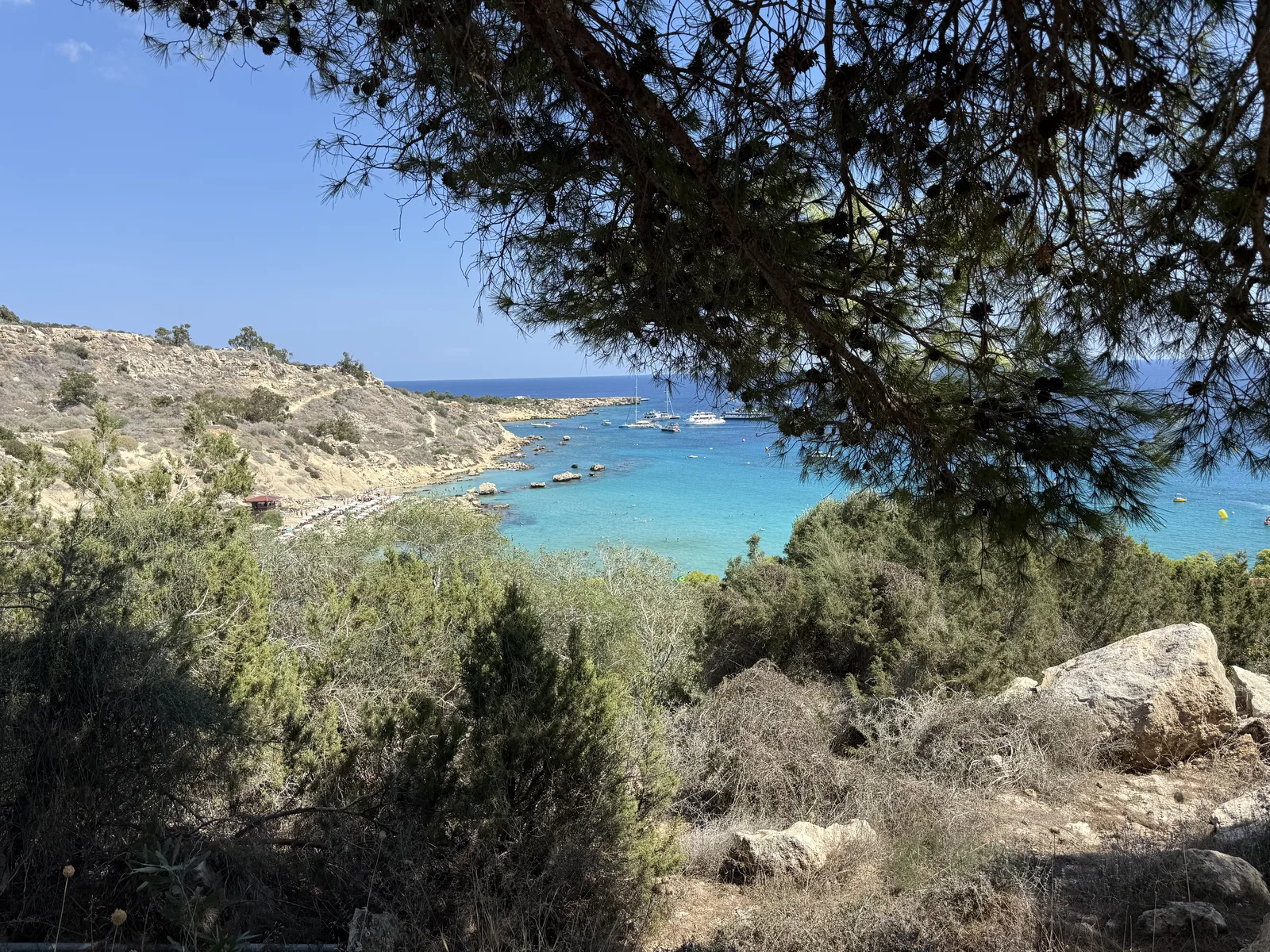 Clear turquoise water and the sheltered cove at Konnos Bay viewed from above